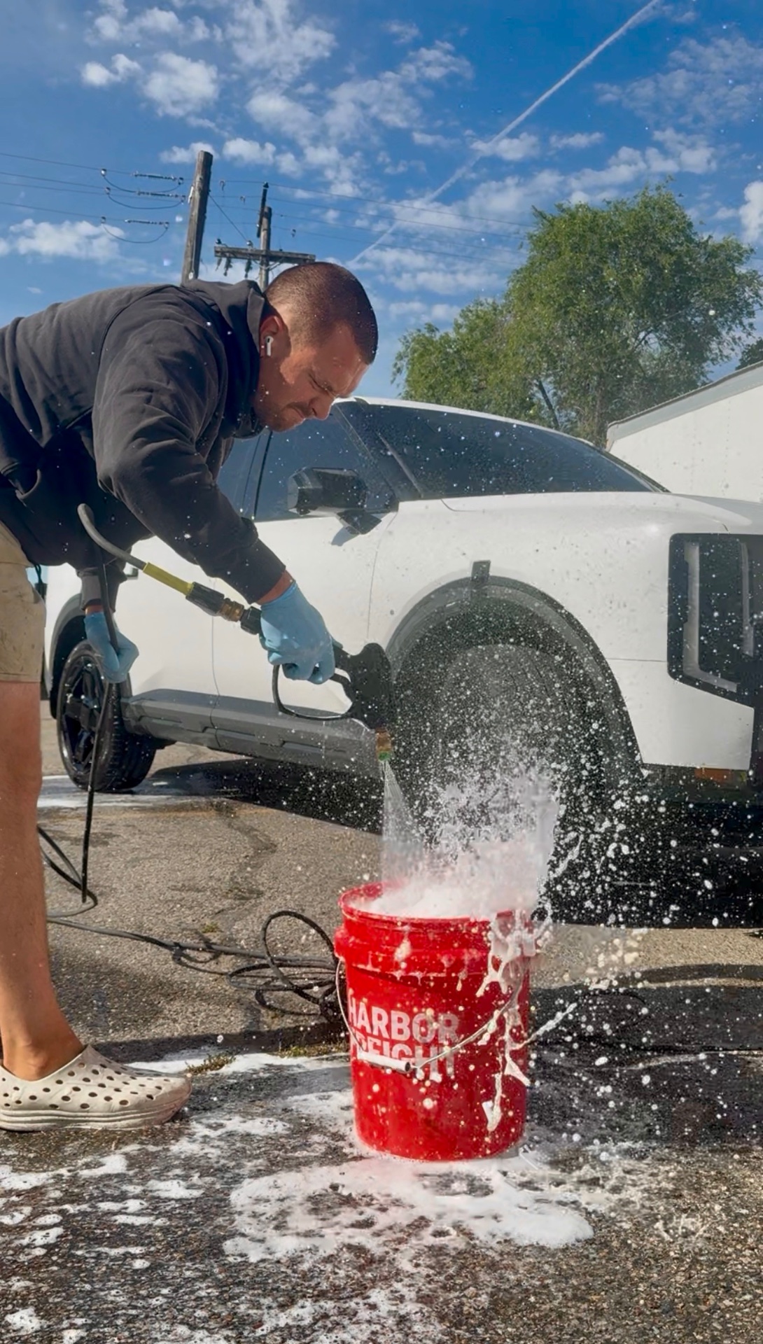 PRO DTLR detailer washing a white vehicle