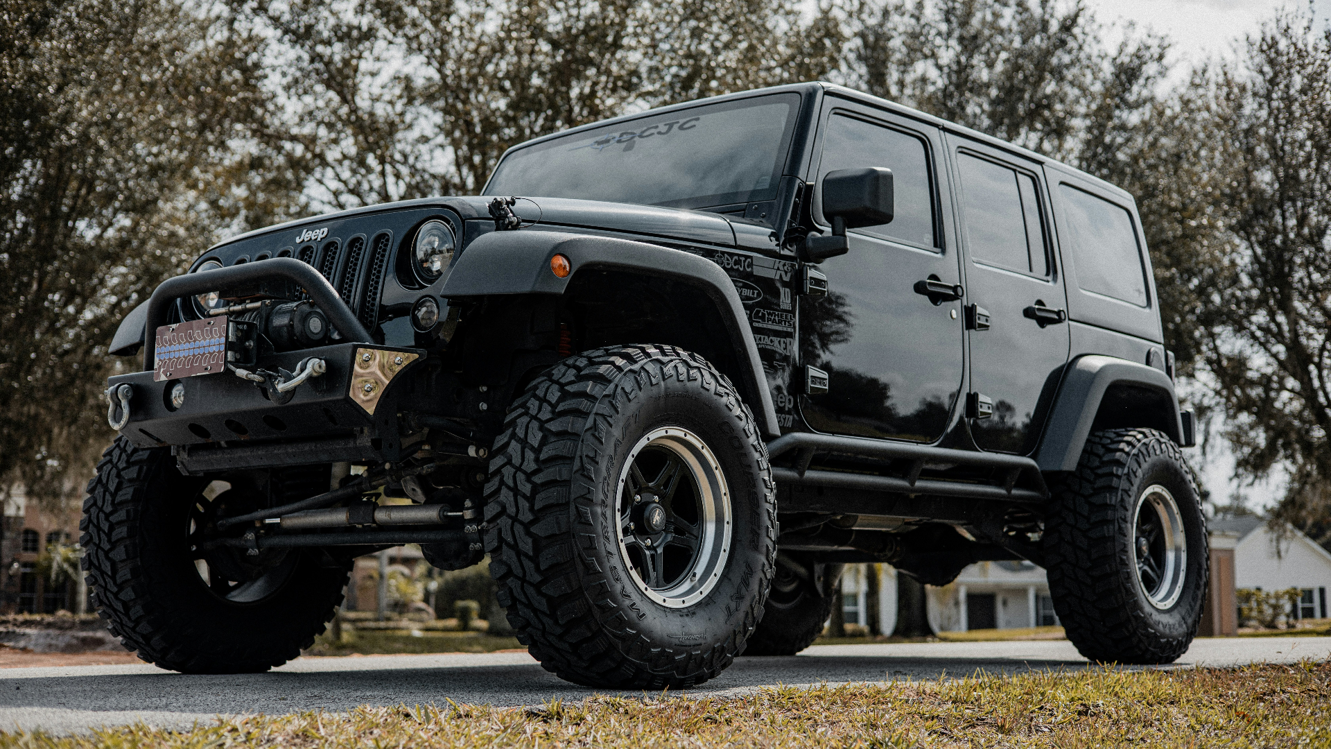 Clean black Jeep Wrangler with off-road tires