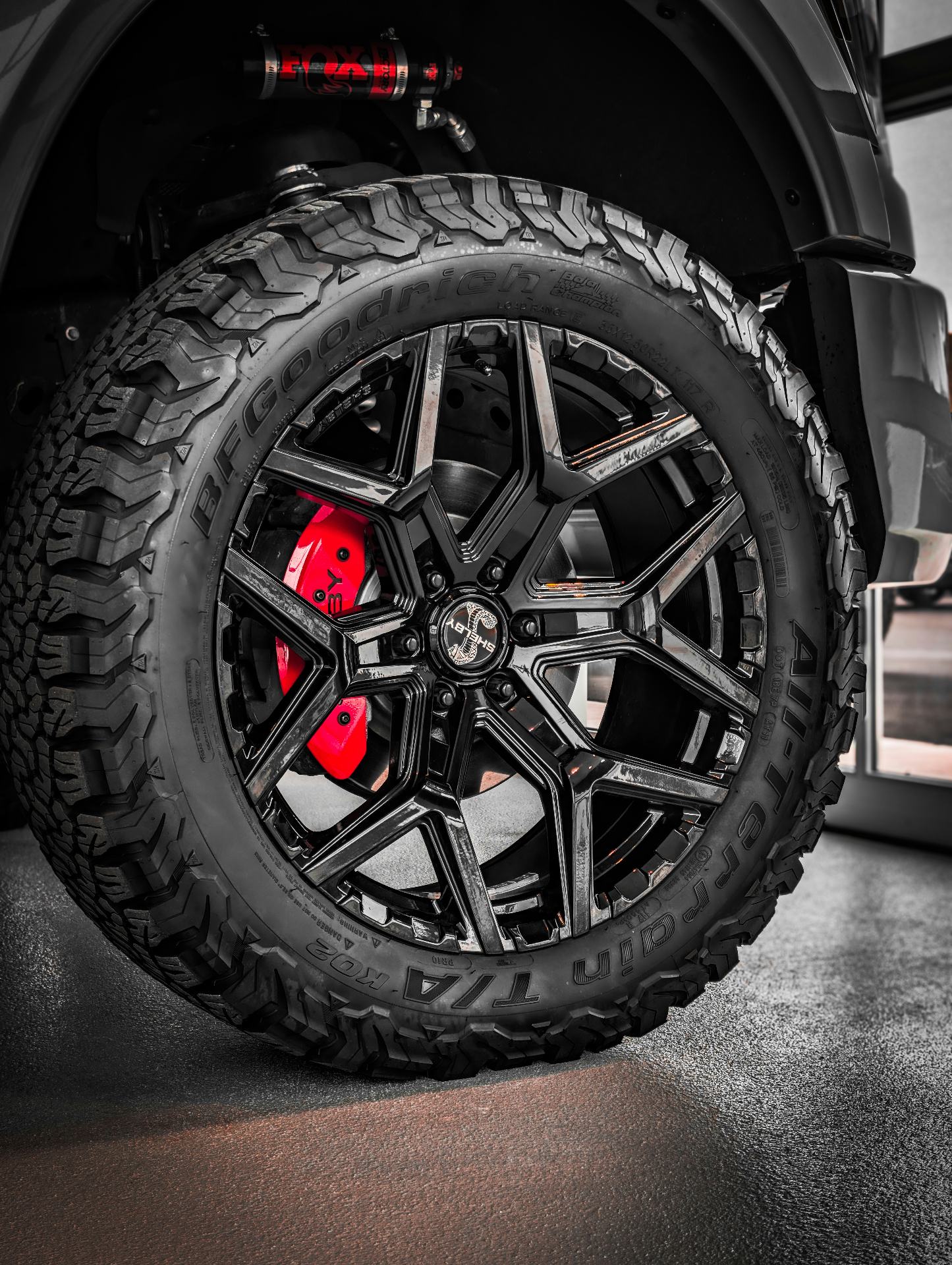 Glossy black truck wheel, tire, and finished trim